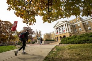A student walking up Bascom Hill