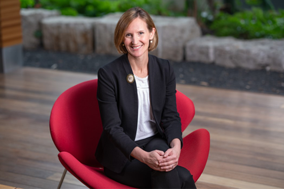 Susan Webb Yackee sits in a chair at the Wisconsin Institutes for Discovery.