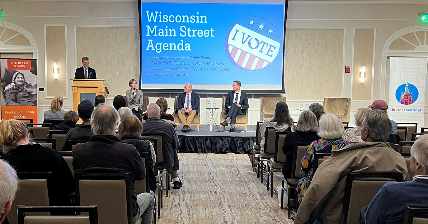 A panel of La Follette School faculty addresses a crowd in Pewaukee, WI.