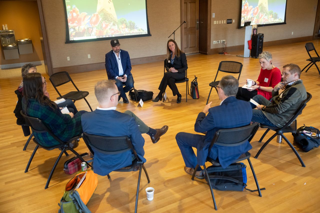 A group of people sits in a circle.
