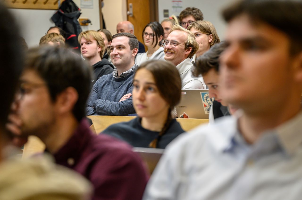 Students sit listening to a presentation