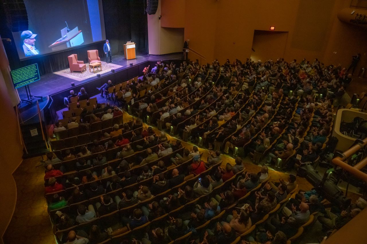 Nate Silver stands on the stage in Shannon Hall and addresses the crowded theater.