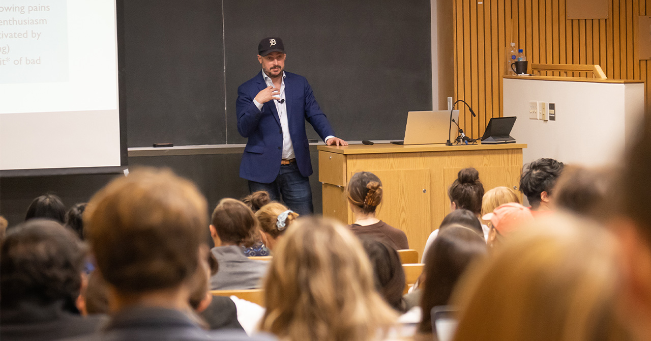 Nate Silver stands at the front of a classroom and answers student questions.