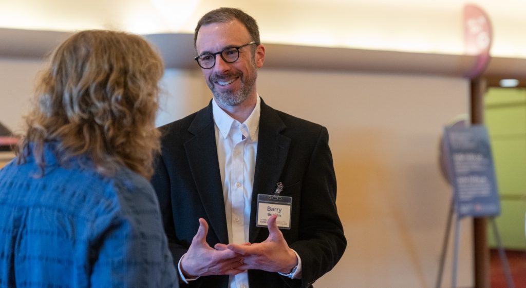 Barry Burden speaks with an event attendee
