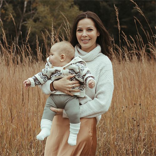 Photo of Karina Virrueta Running holding her son, Roman.