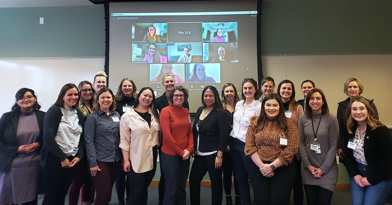Group photo of seminar attendees and instructors with some joining remotely.