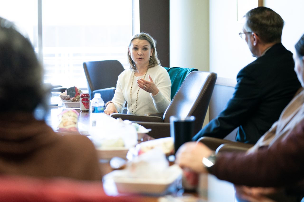 Tamara Keith sits at a table with area journalists.