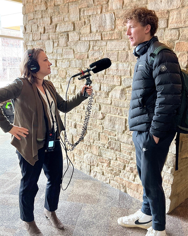 Tamara Keith holds a microphone up to a student being interviewed in Union South.