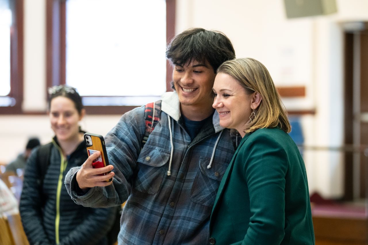 A student takes a selfie with Tamara Keith