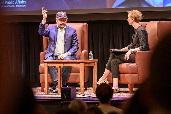 Nate Silver and Susan Yackee sit on a stage during a question and answer session