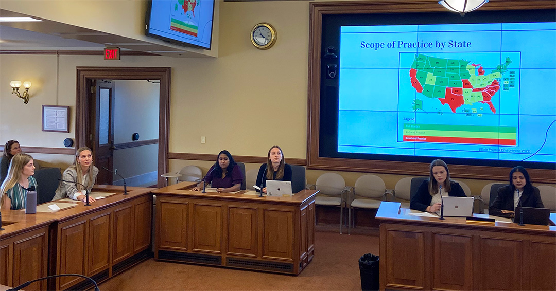 Students present slides of their report in the Wisconsin State Capitol