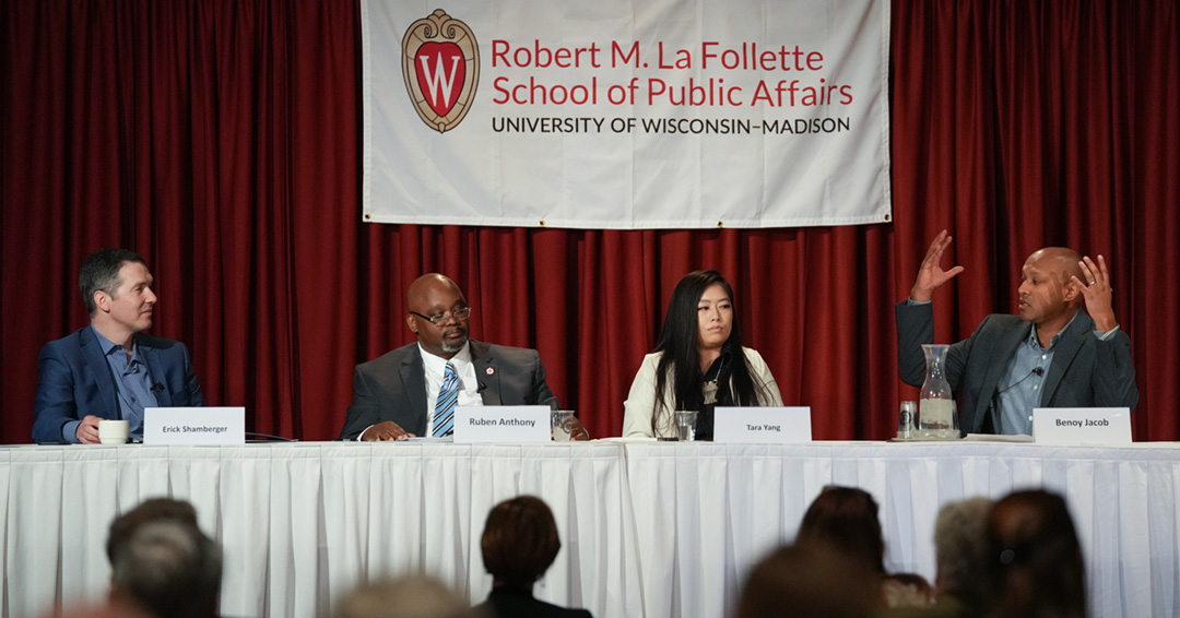 Panelists sit at a table on a stage during the 2023 La Follette Forum