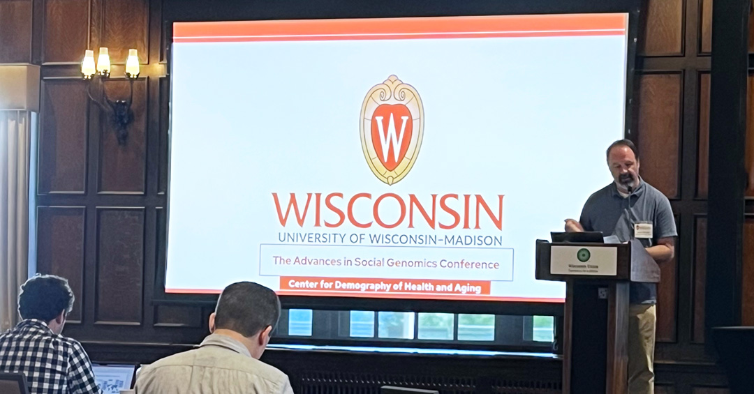 Jason fletcher addresses audience members at a conference.