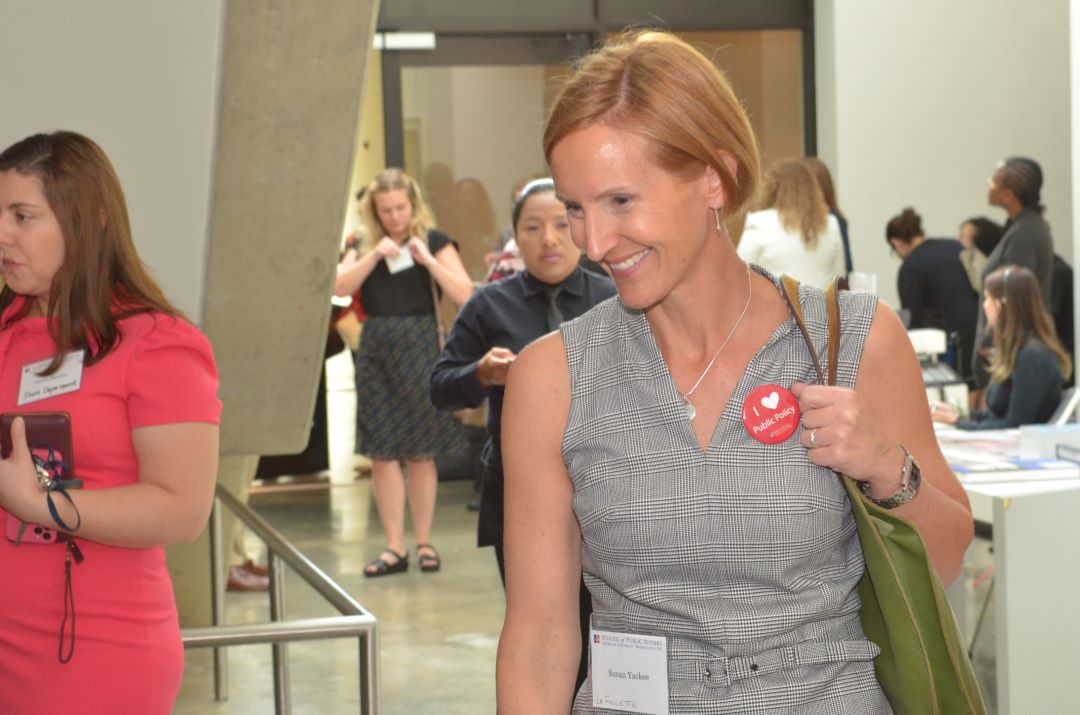 Susan Webb Yackee walking into a room during the event