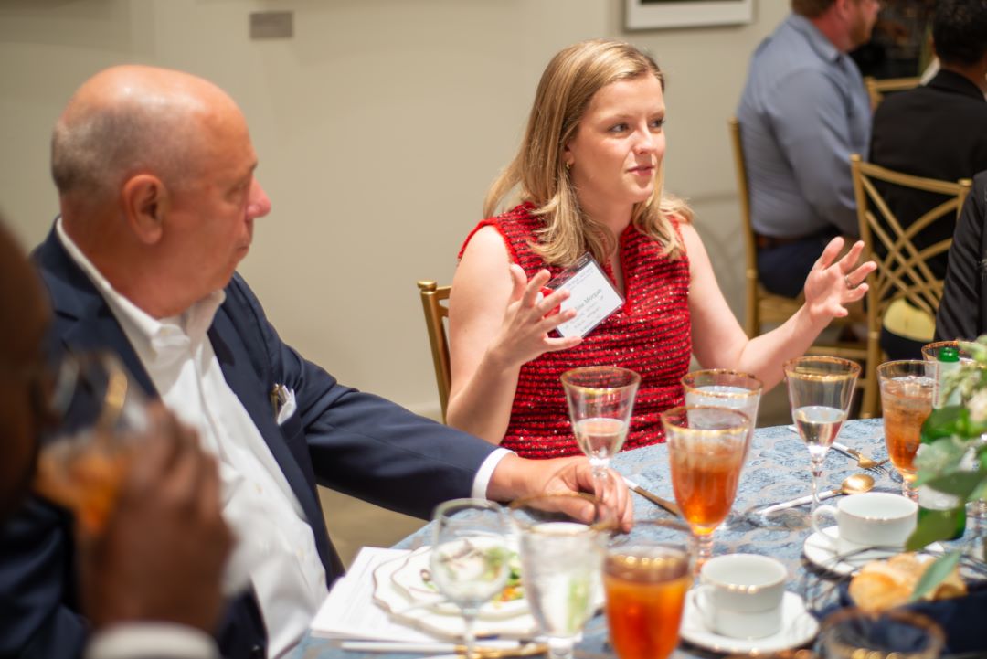 Madeline Morgan talks to other attendees at the table, including Mike Fasano 