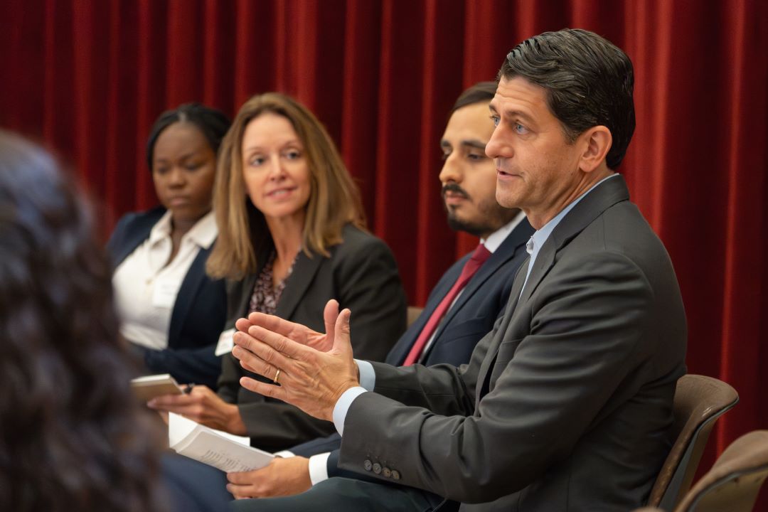 Paul Ryan gestures while talking to students