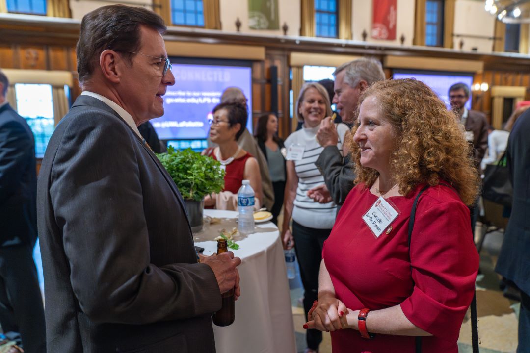 Representative David Murphy and Chancellor Jennifer Mnookin stand chatting during a reception in Memorial Union's Tripp Commons