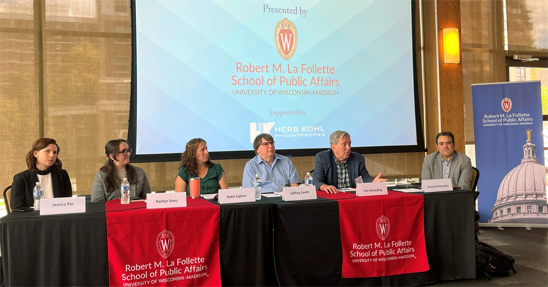 Panelists sit at a table together in the Pyle Center