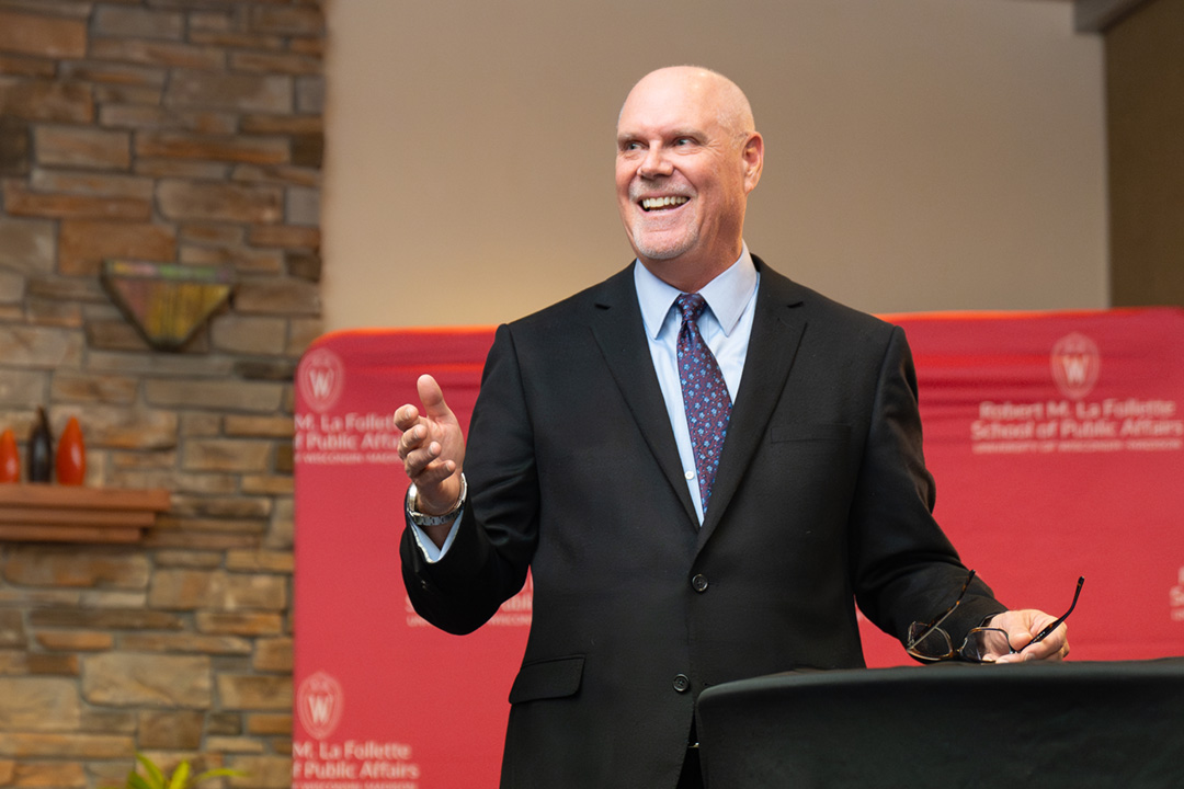 Jack Salzwedel stands at a podium during a reception.
