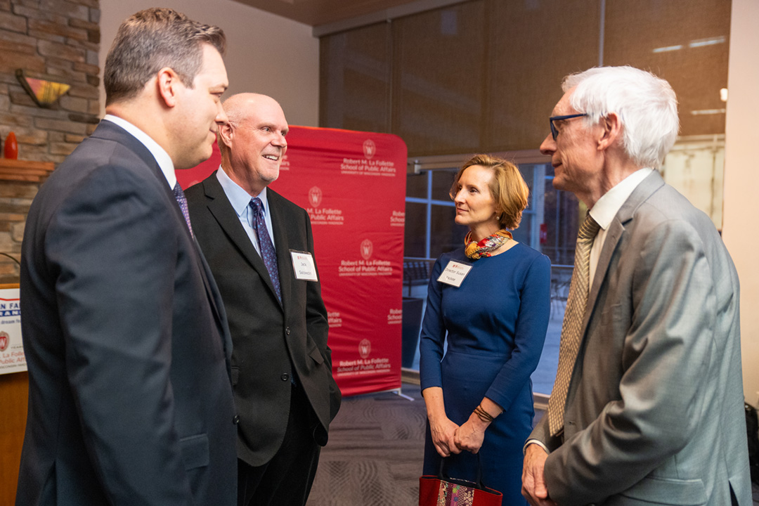 Jack Salzwedel speaks with Bill Westrate, Susan Yackee, and Governor Tony Evers during a reception.