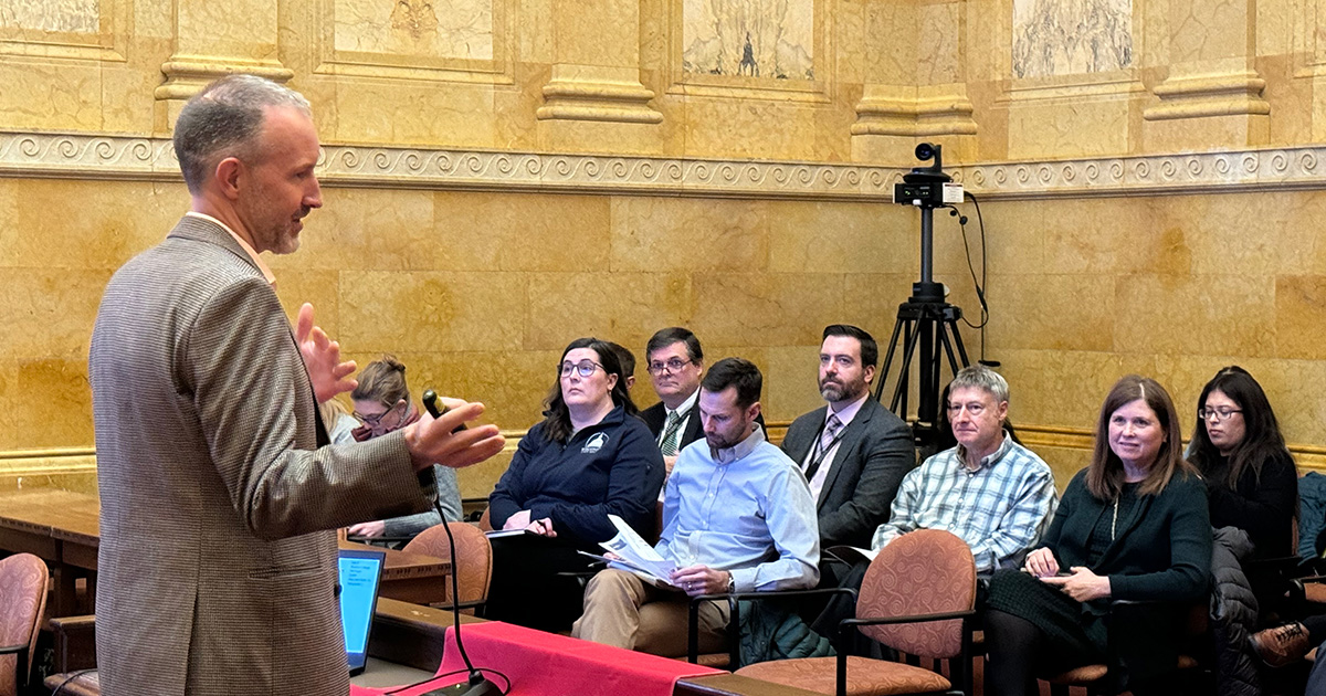 J. Michael Collins presents to policymakers at the Wisconsin State Capitol