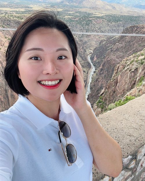 Minjung Jun takes a selfie in front of a canyon vista