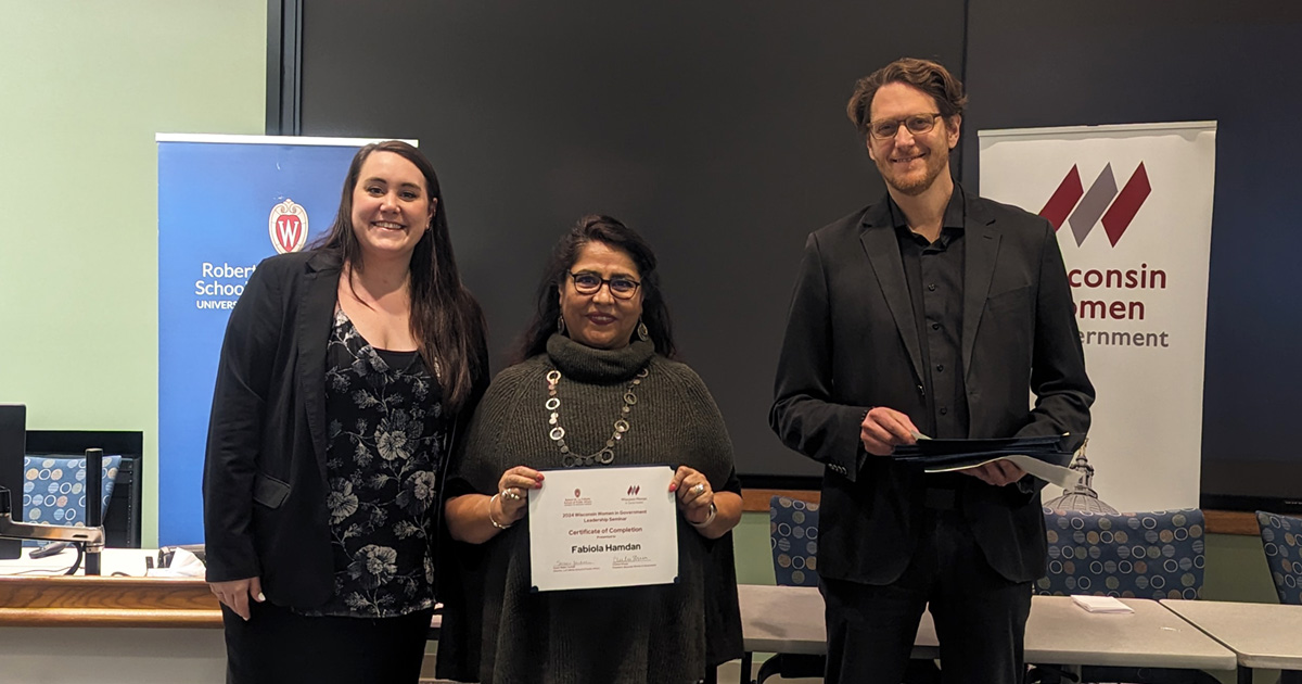 Greg Nemet and Chelsea Shanks stand with a participant holding a certificate