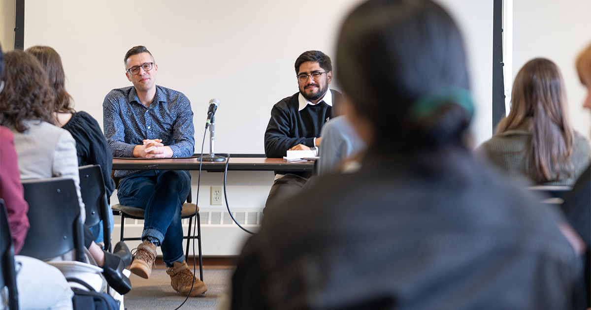 Ezra Klein listens to a student's question in a classroom.