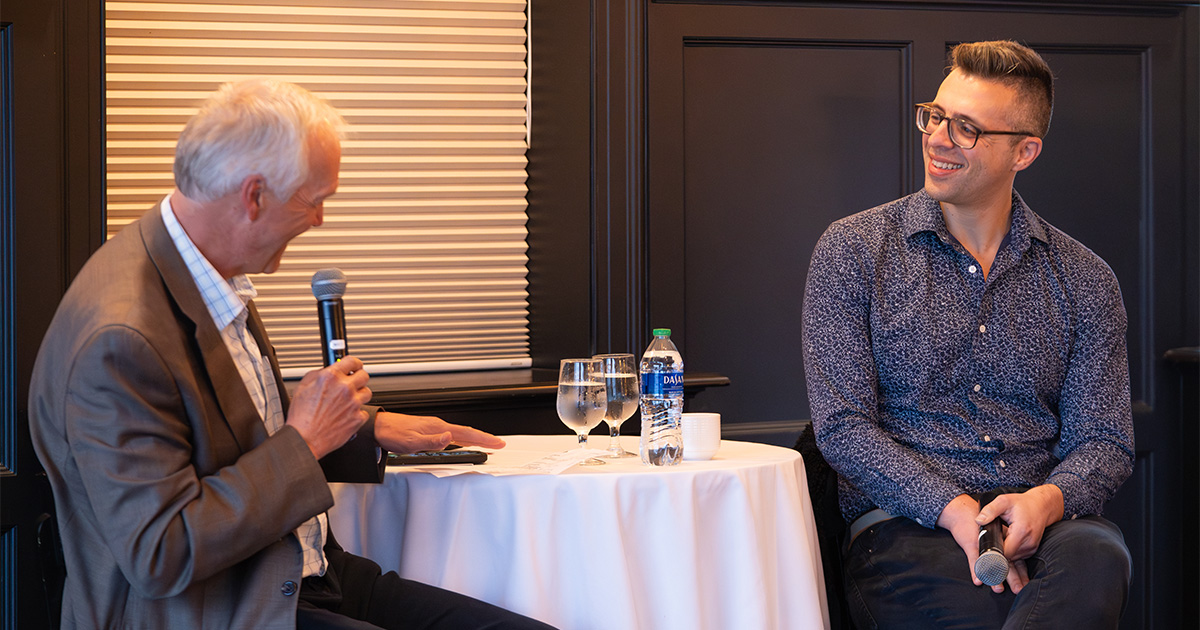Jeff Mayers asks Ezra Klein a question while they sit together in the Madison Club