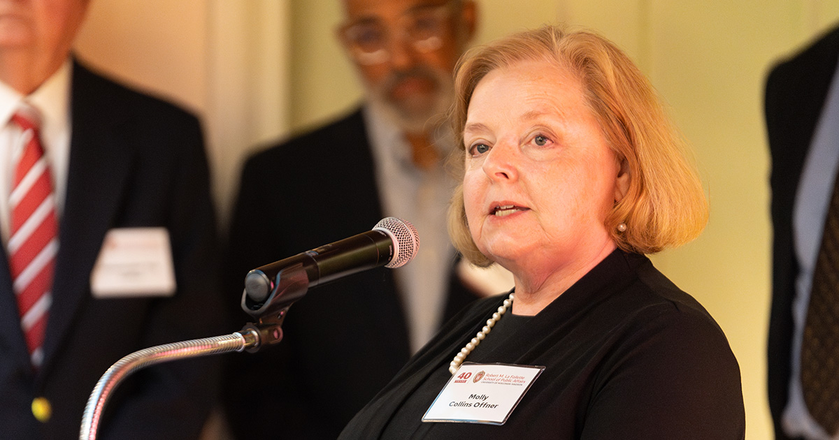 Molly Collins Offner speaks at a podium