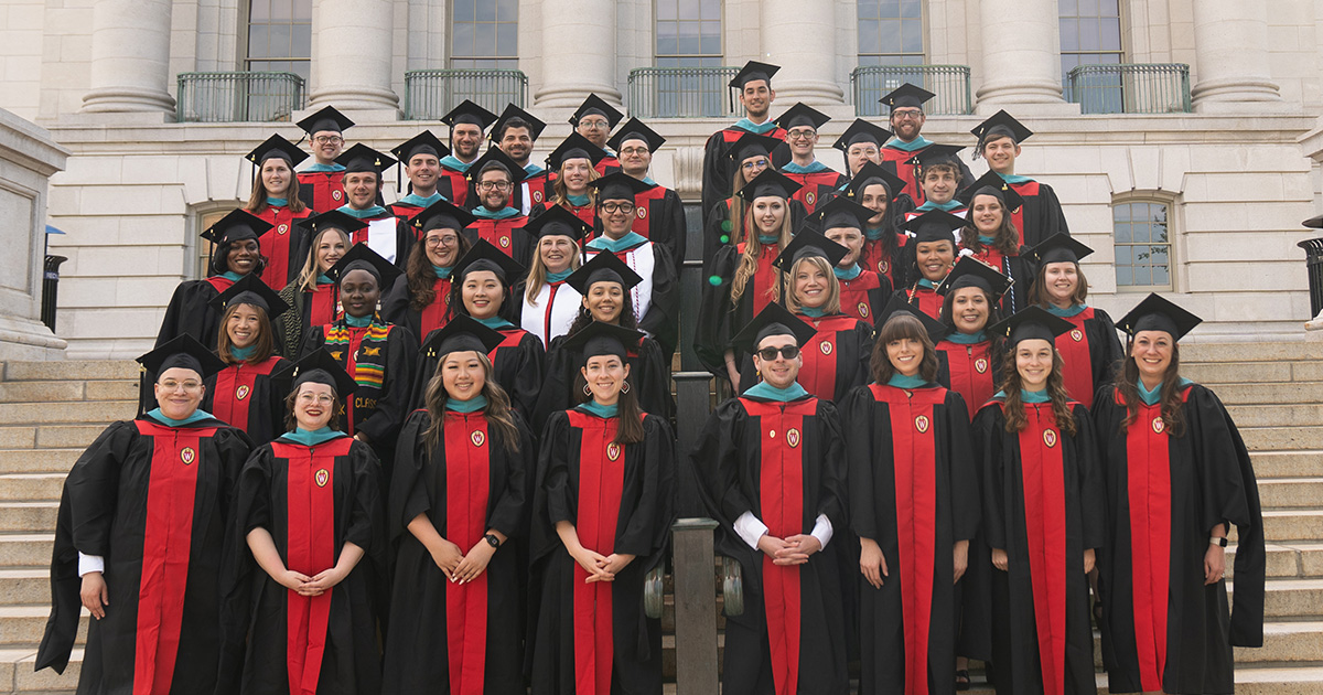 Graduates of the La Follette School's master's degree class of 2024 stand on the steps of the Wisconsin State Capitol