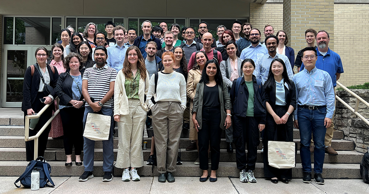 Conference attendees pose for a photo outside of the Pyle Center