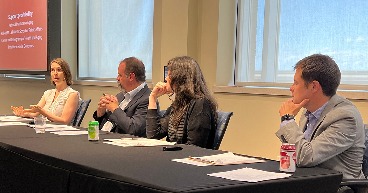 Panelists speak at a table