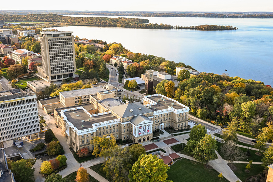 An aerial photo of Bascom Hall in the fall with Lake Mendota behind