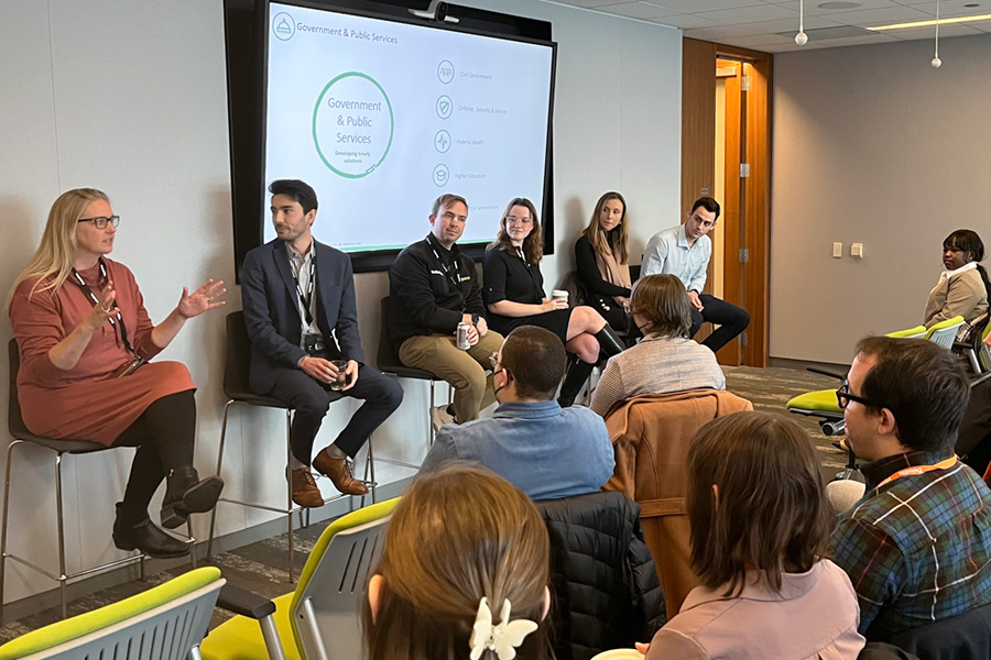 Students listen to a presentation from alumni working at Deloitte.