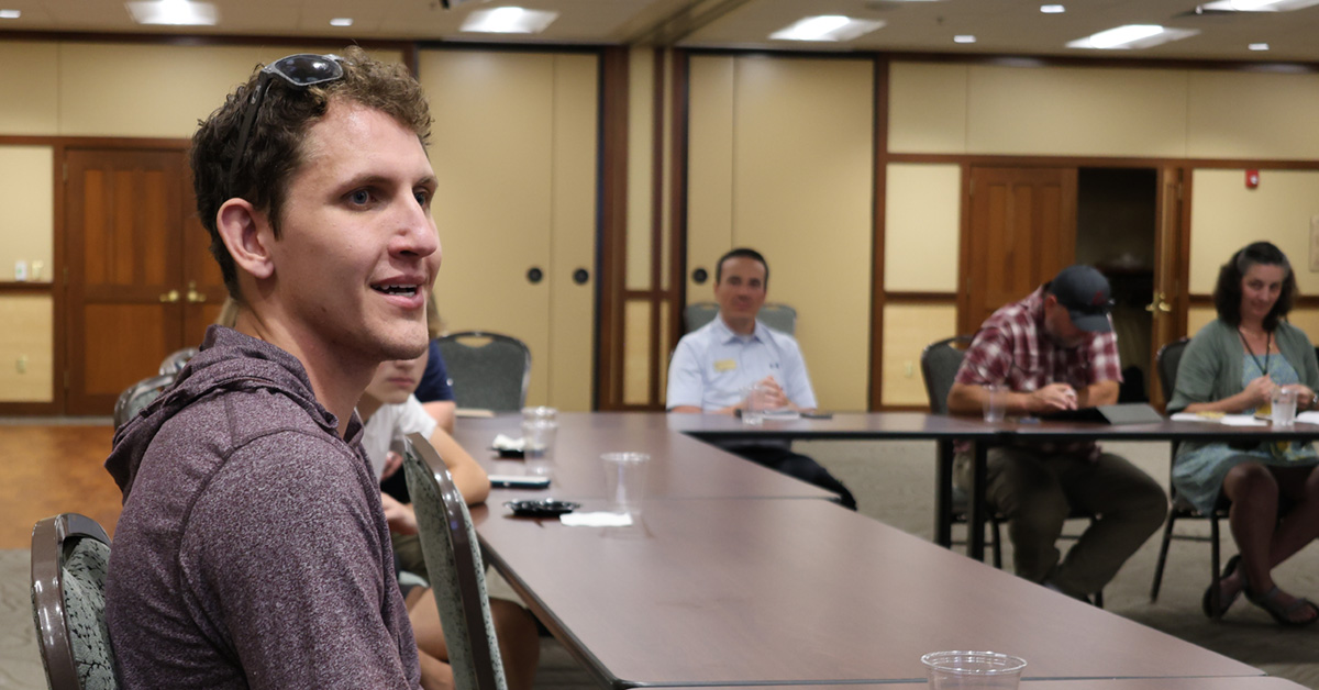 An attendee at the Lacrosse town hall asks a question to panelists.