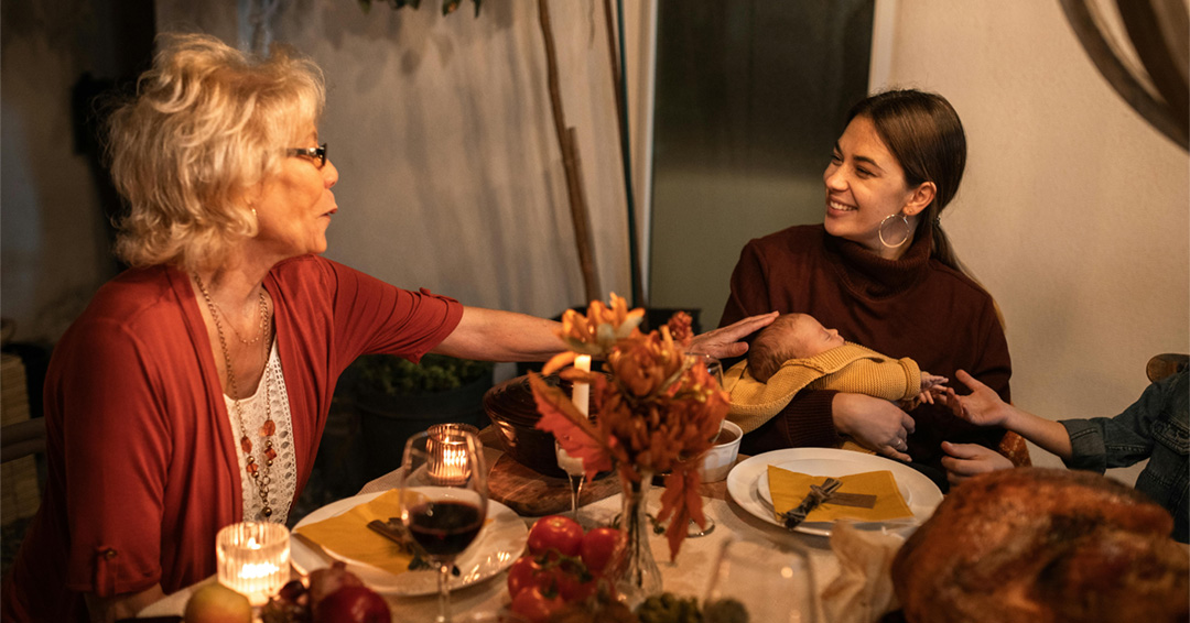 Two people talk during a holiday meal.