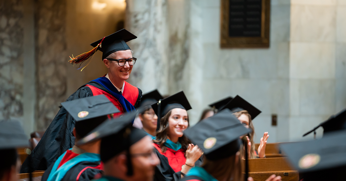 Abigail Swetz and other graduates wearing caps and gowns at the La Follette School graduation ceremony