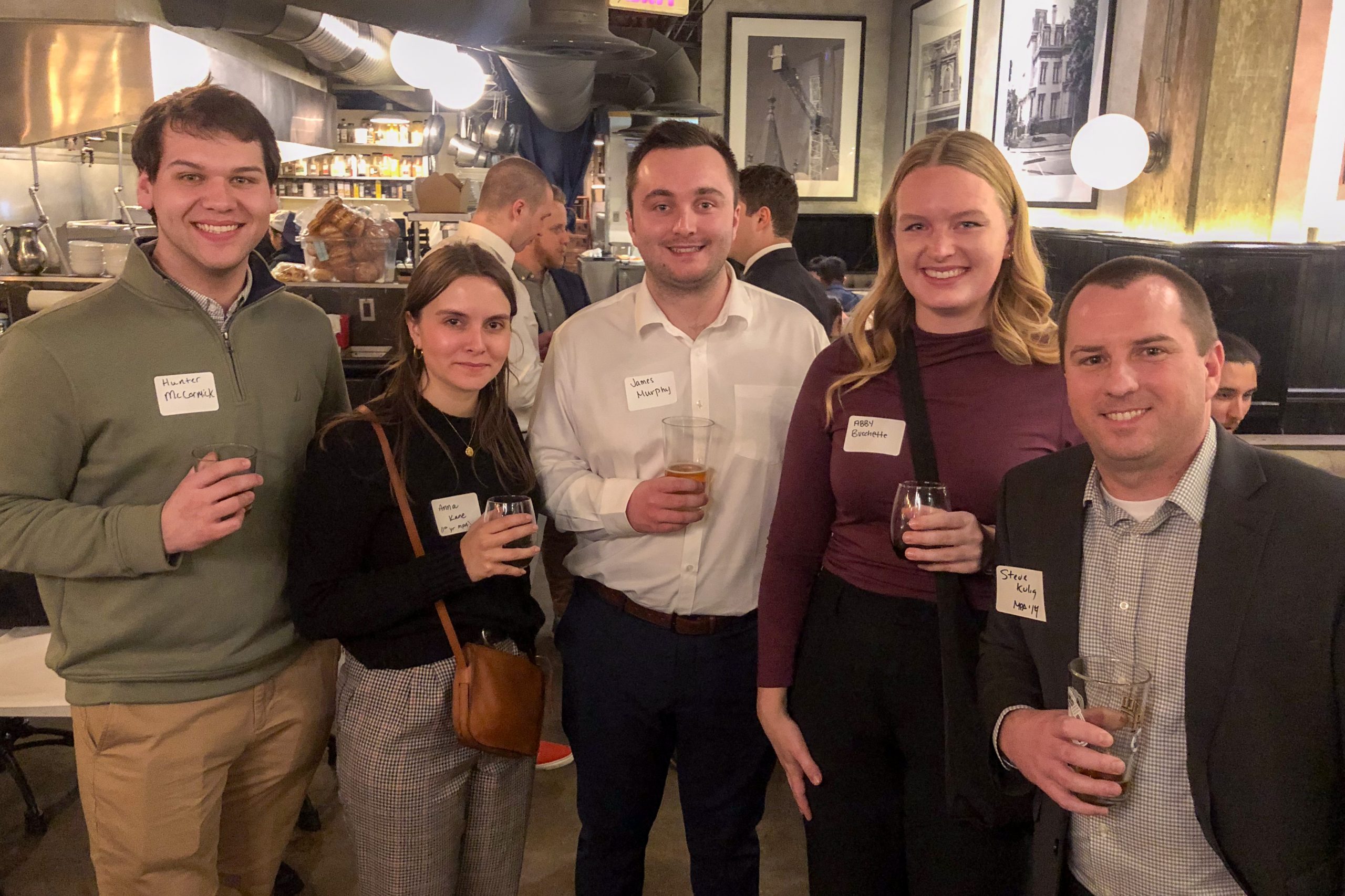 A group of people pose for a photo at the alumni and friends reception.