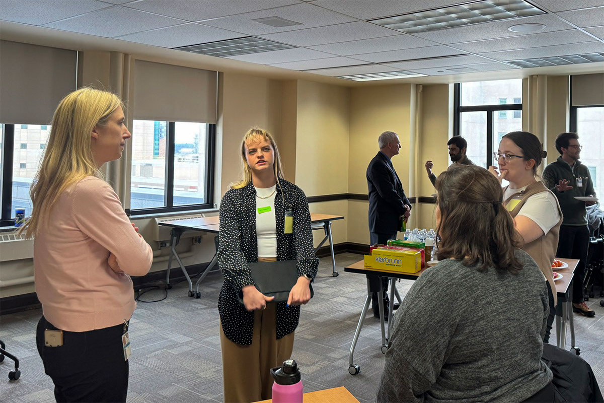 Student networking with Caroline Ellerkamp (DHS) and Lisa Galvan (DHS) in forefront