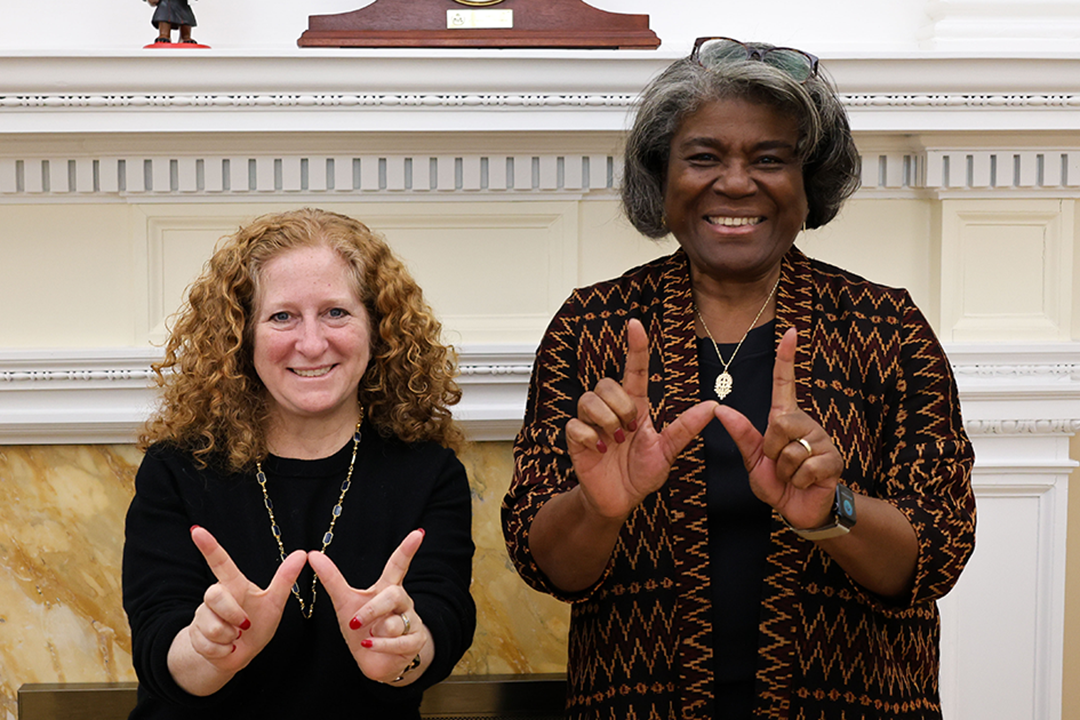 Chancellor Jennifer Mnookin poses for a photo with Linda Thomas-Greenfield. Both hold their hands in the shape of a "W."