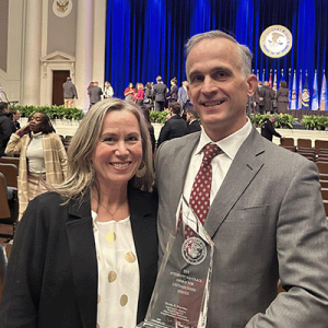 Daniel Maxwell poses with his wife Katherine at an award ceremony