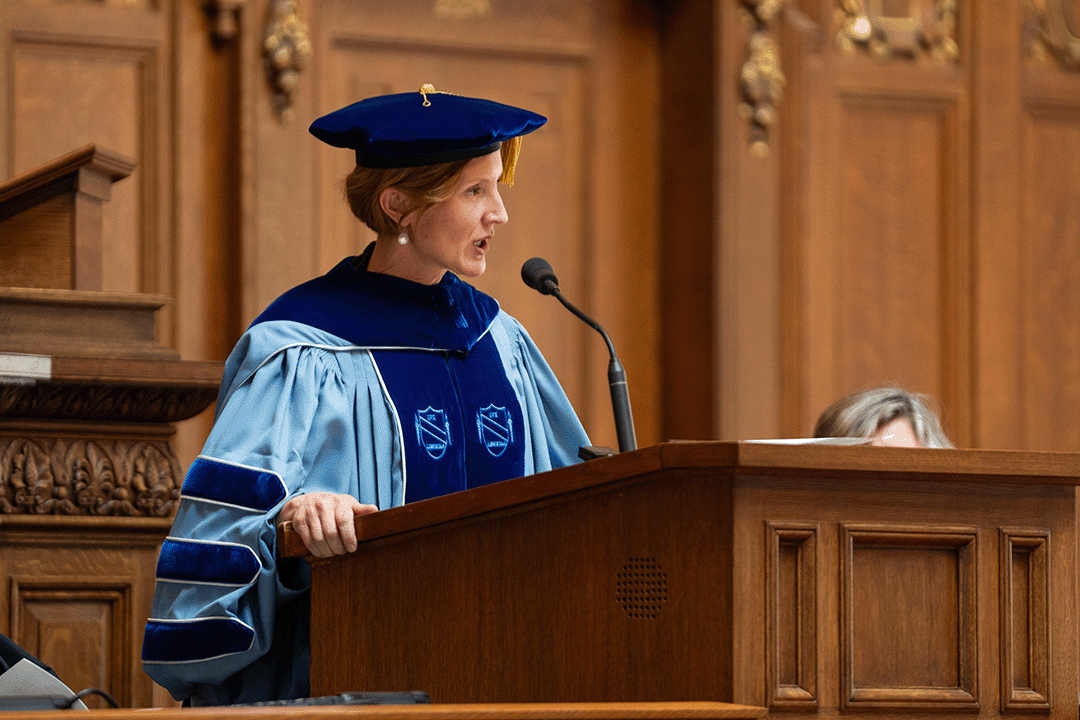 Susan Yackee speaks at podium