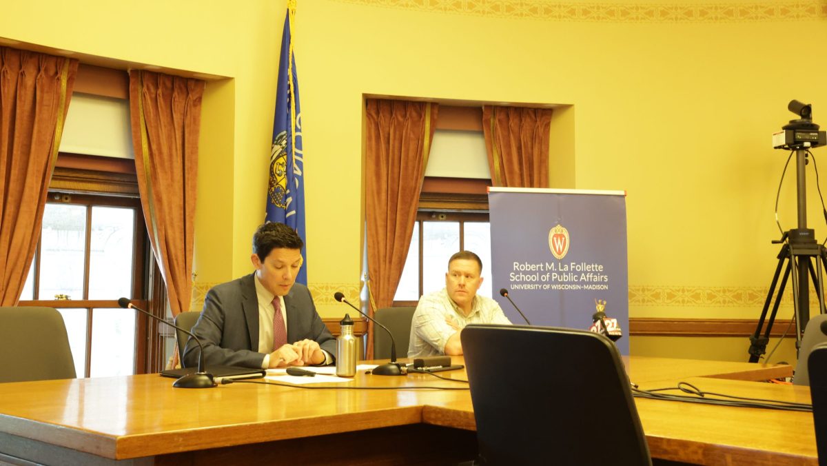 Professor Manny Teodoro and Alex Parker seated at a table