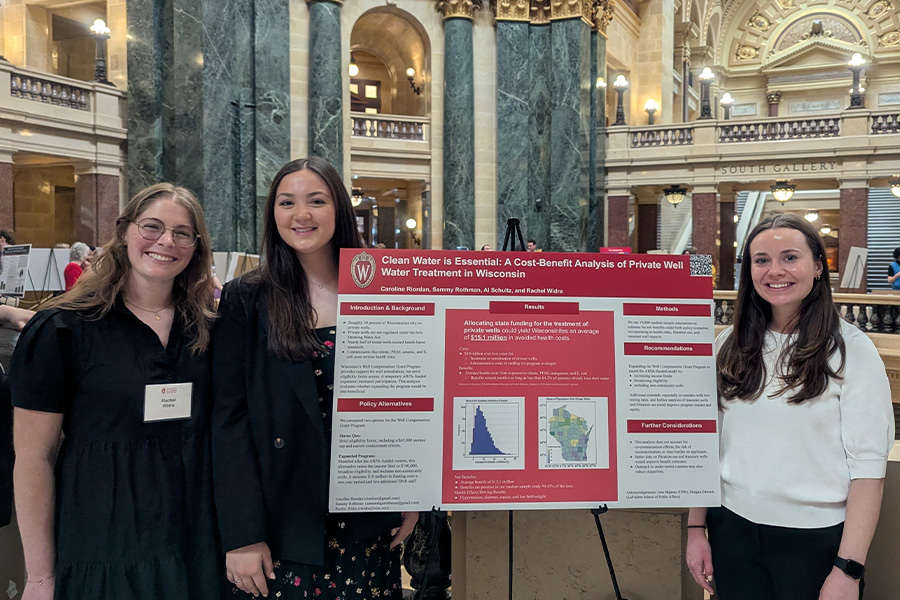 Students present a poster in the Wisconsin State Capitol Rotunda.