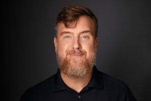 Professional headshot of Greg Lukianoff smiling at the camera.