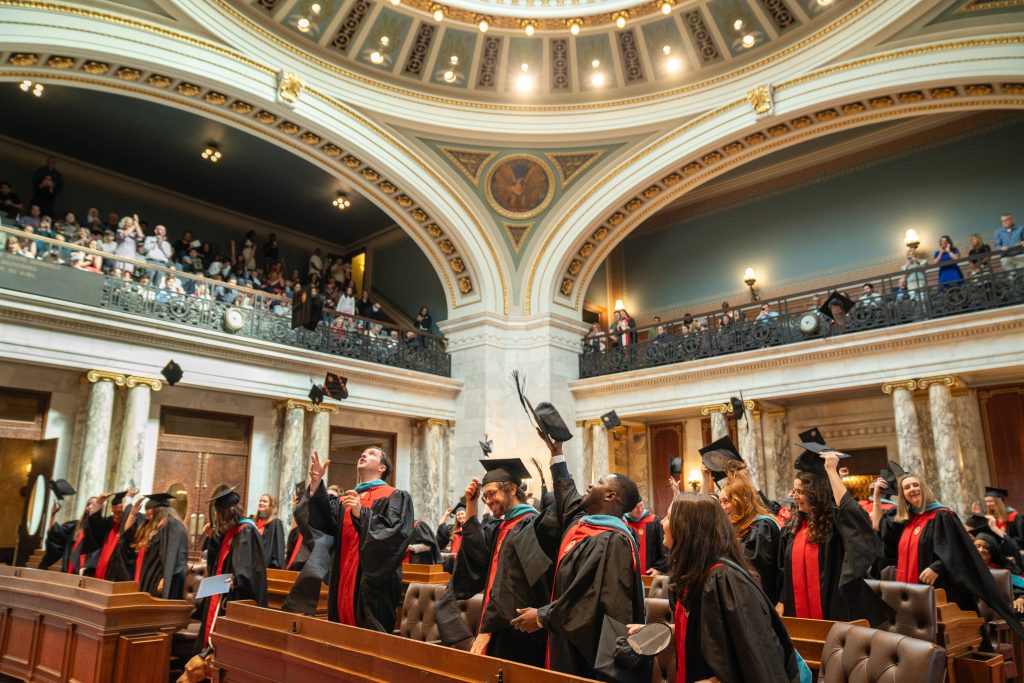 Graduates throw their caps during the 2025 graduation ceremony.