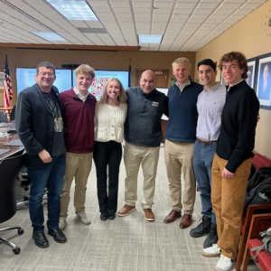 David Henke, Seth Rosenman, Eva Hetzel, Ryan Zollicoffer, Malcolm Lewis, Ben Hayum, and Jude Ogden stand together.