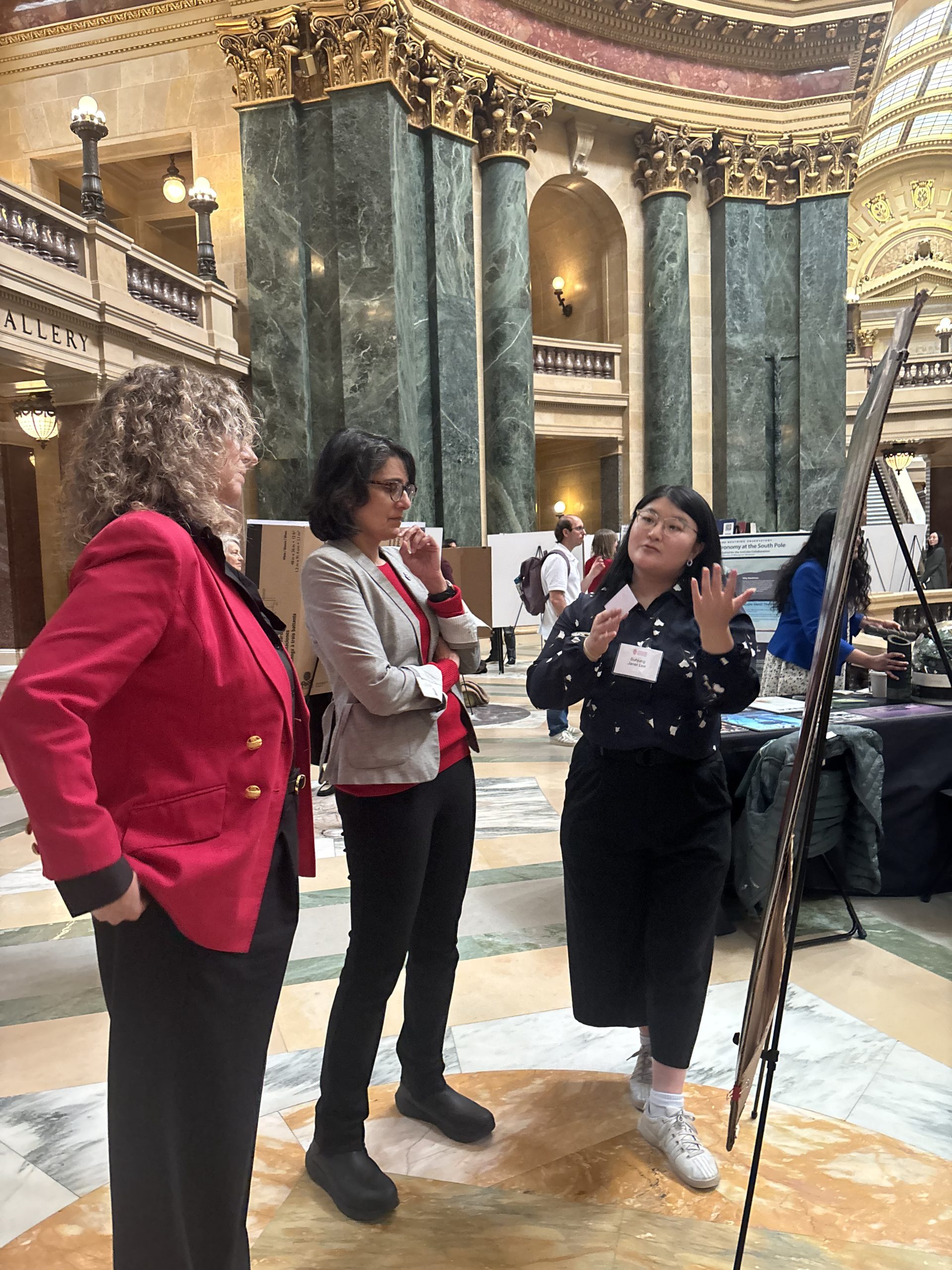 LFS student Janet Lee explains her research to Representatives Mayadev and DeSanto.