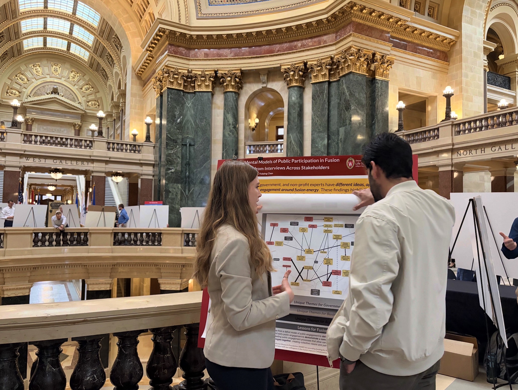 LFS student Jacklyn Alsbro explains her research to fellow LFS student.